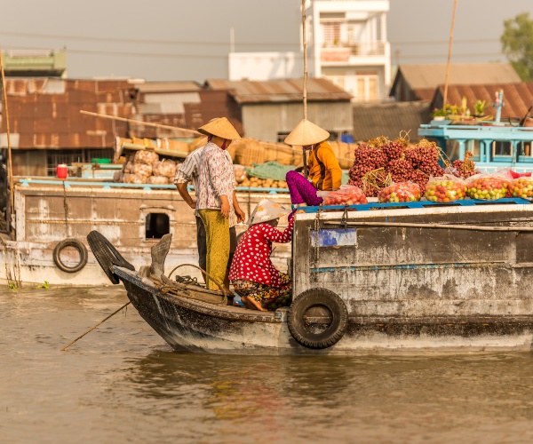 Boat arriving in floating market Mekong Delta