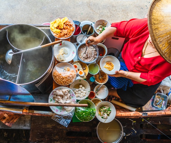 Food vendor at Damnoen Saduak floating market Thailand