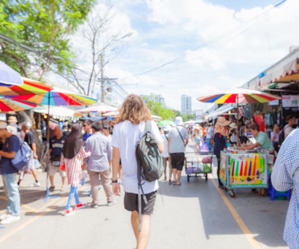 Tourist walking through Chatuchak Weekend Market Bangkok